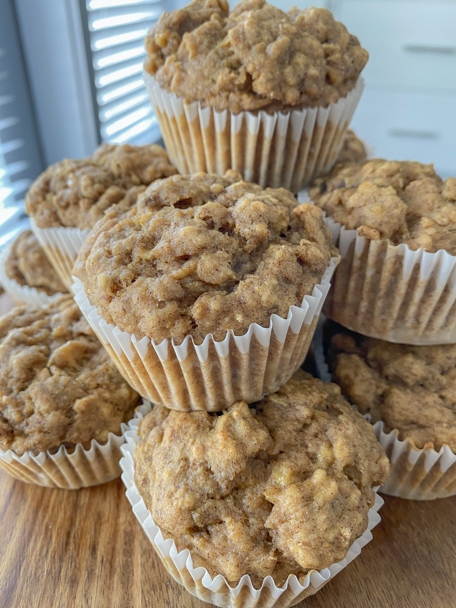 Vegan Oatmeal Banana Muffins stacked on top of each other.