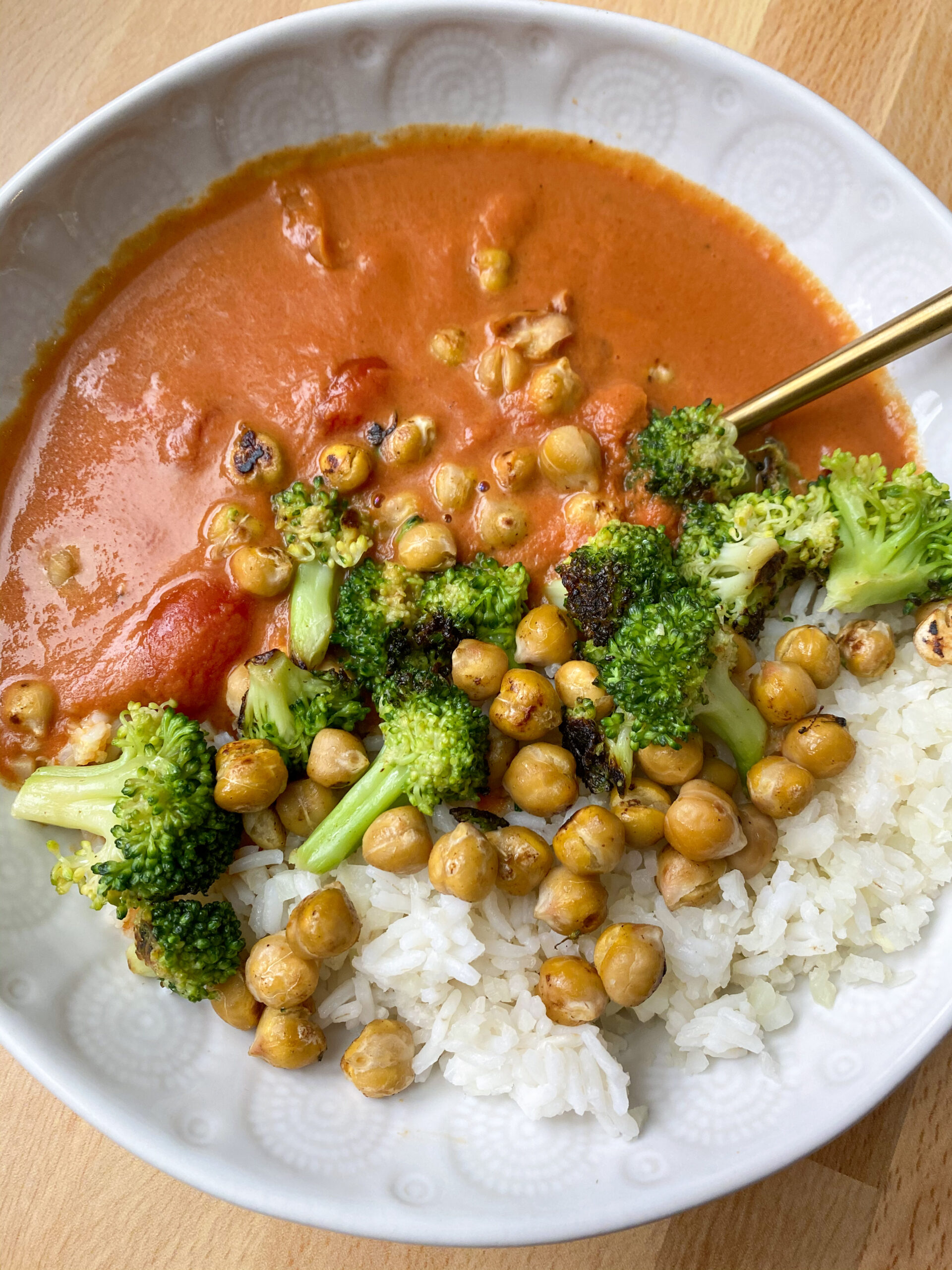 Easy Vegan Tomato Curry served over rice with broccoli and chickpeas.