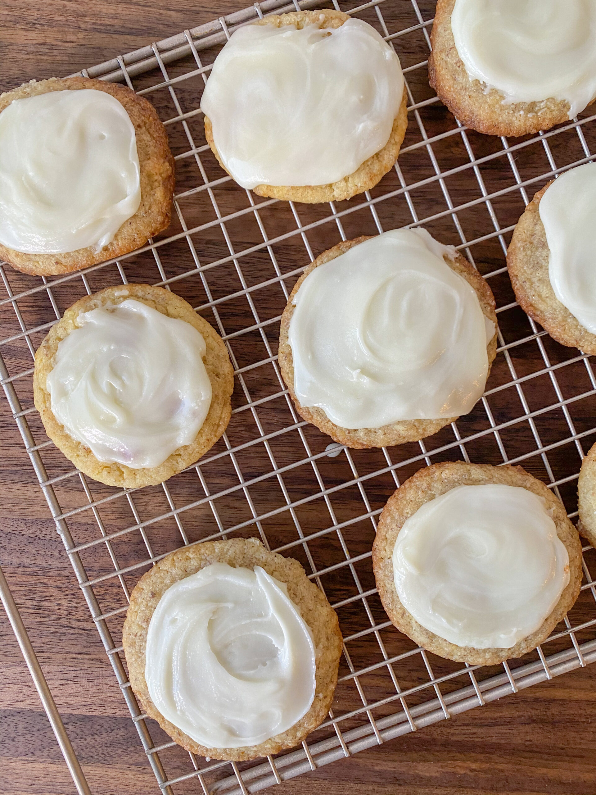Vegan Sugar Cookies with icing on a wire cooling rack.