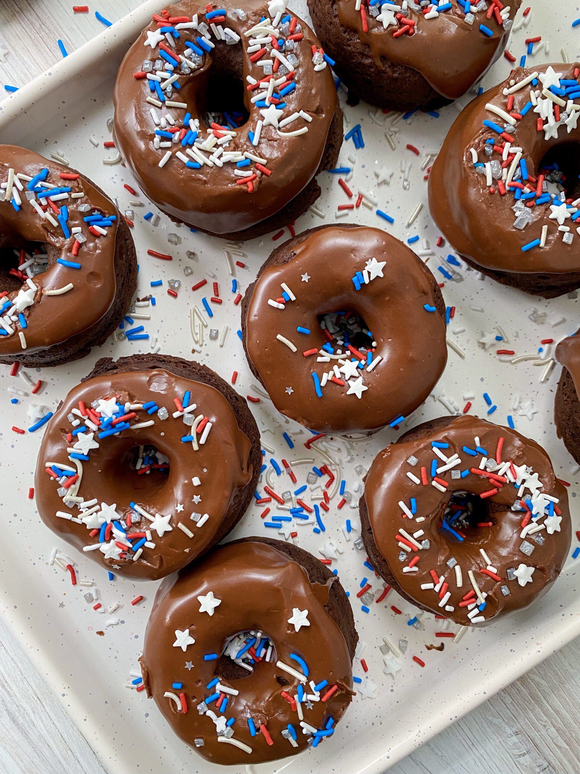 4th of July Vegan Chocolate Donuts on a white serving tray.