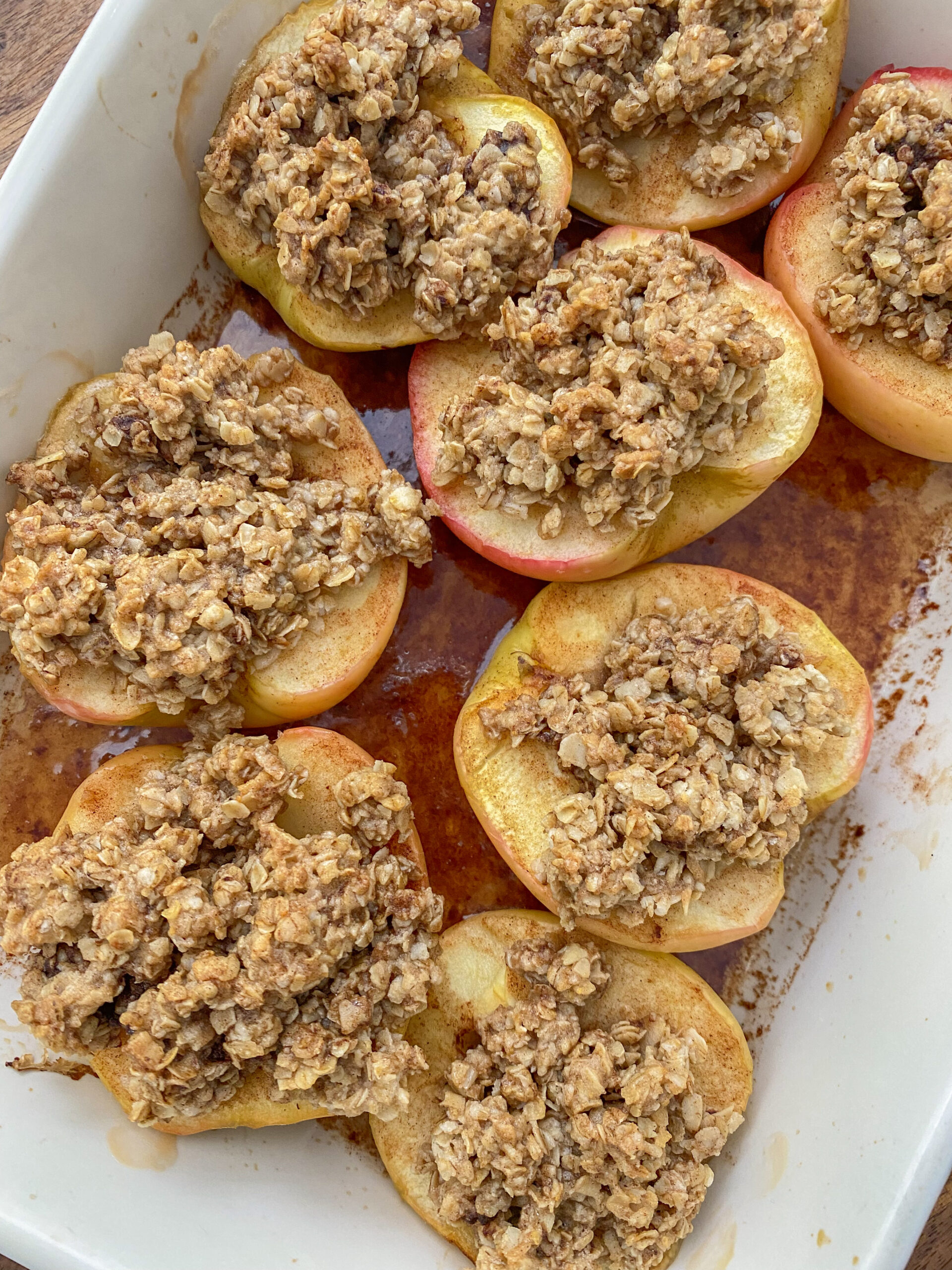 vegan baked apples in a casserole dish after being baked. 