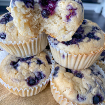 Lemon blueberry muffins stacked on top of each other.