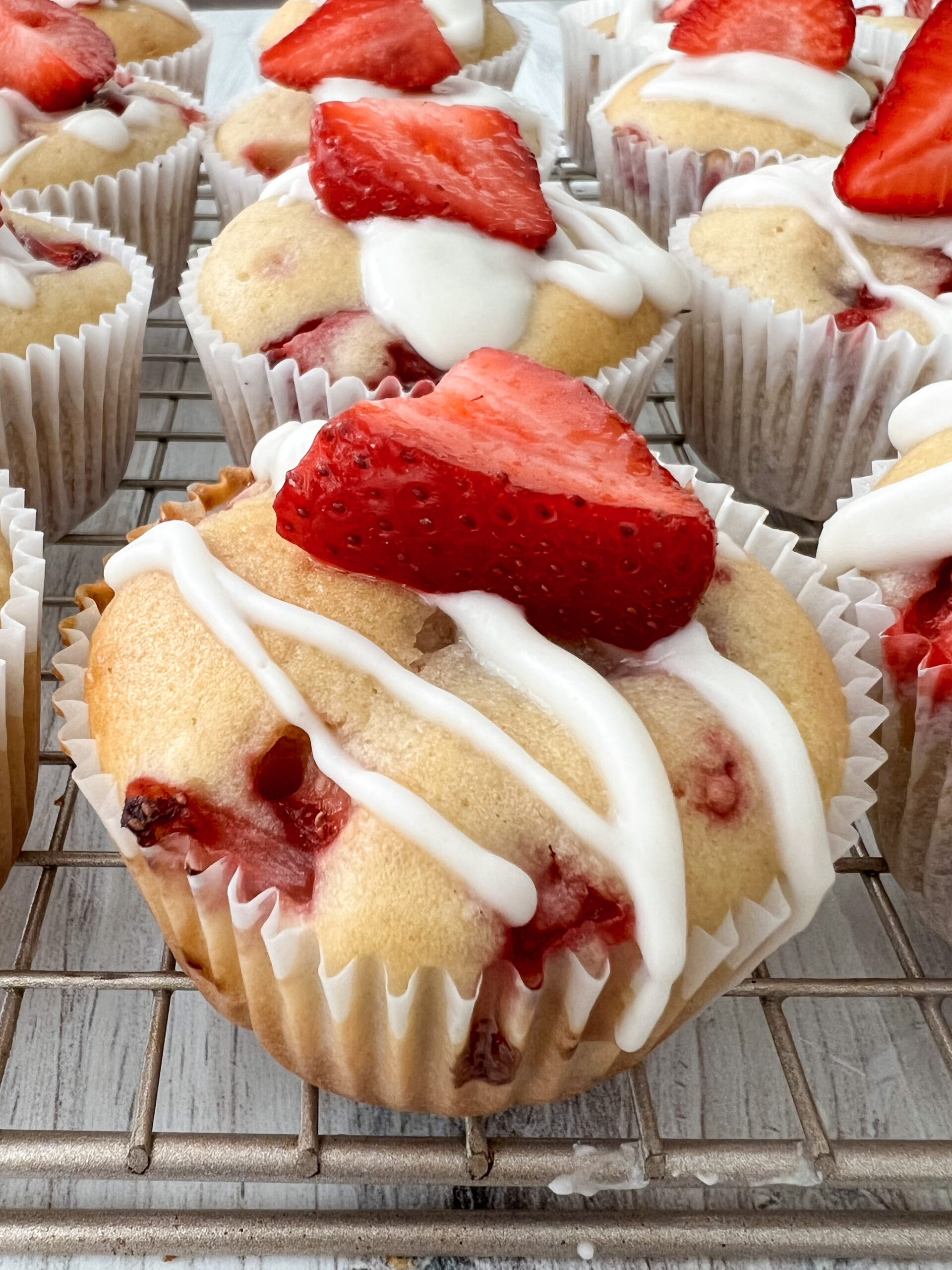 Strawberry shortcake cupcake topped with icing.