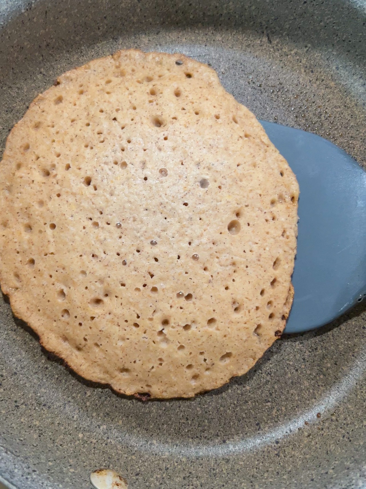 frying pancake until bubbles form