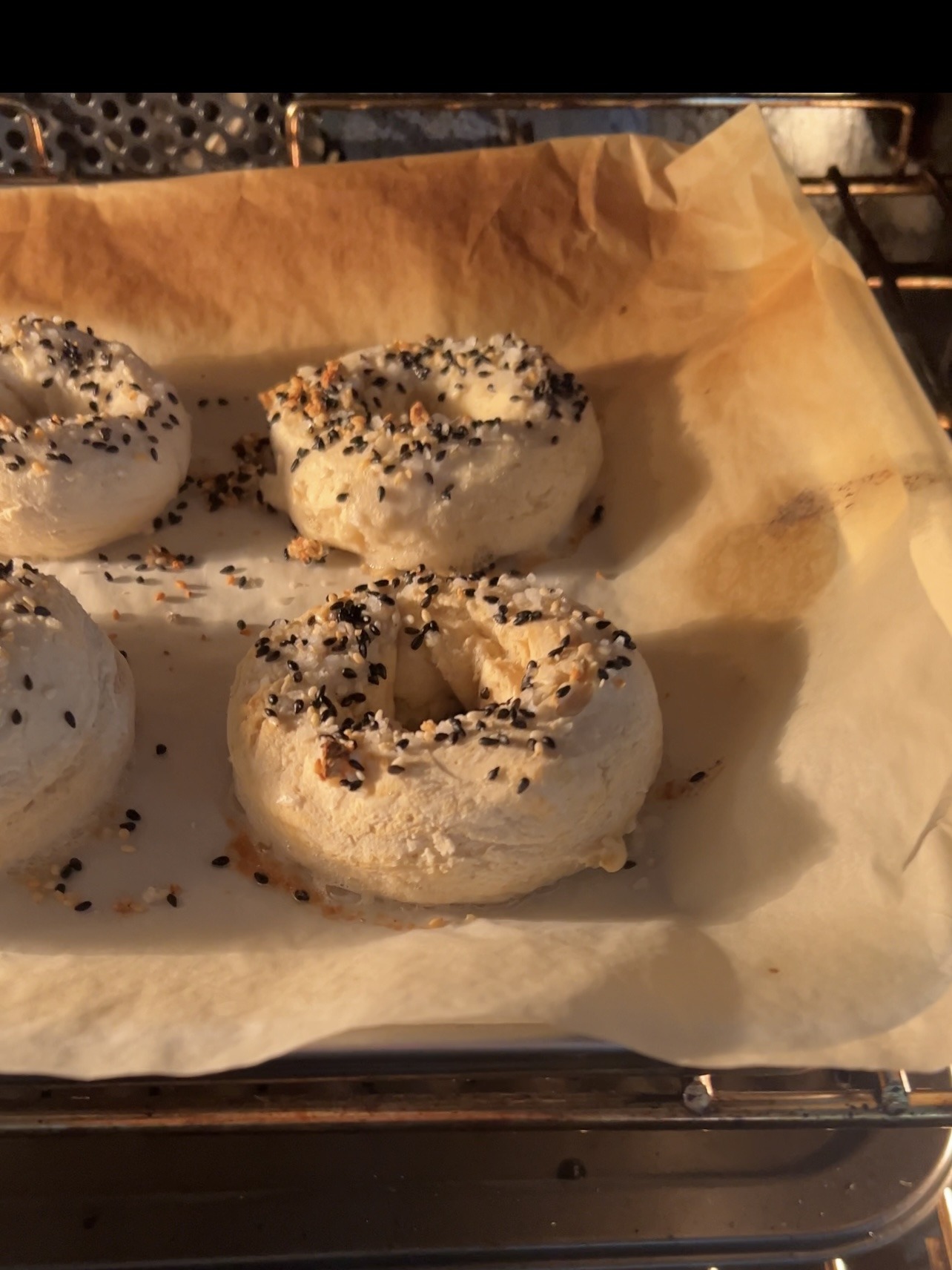 Broiling homemade bagels in the oven.
