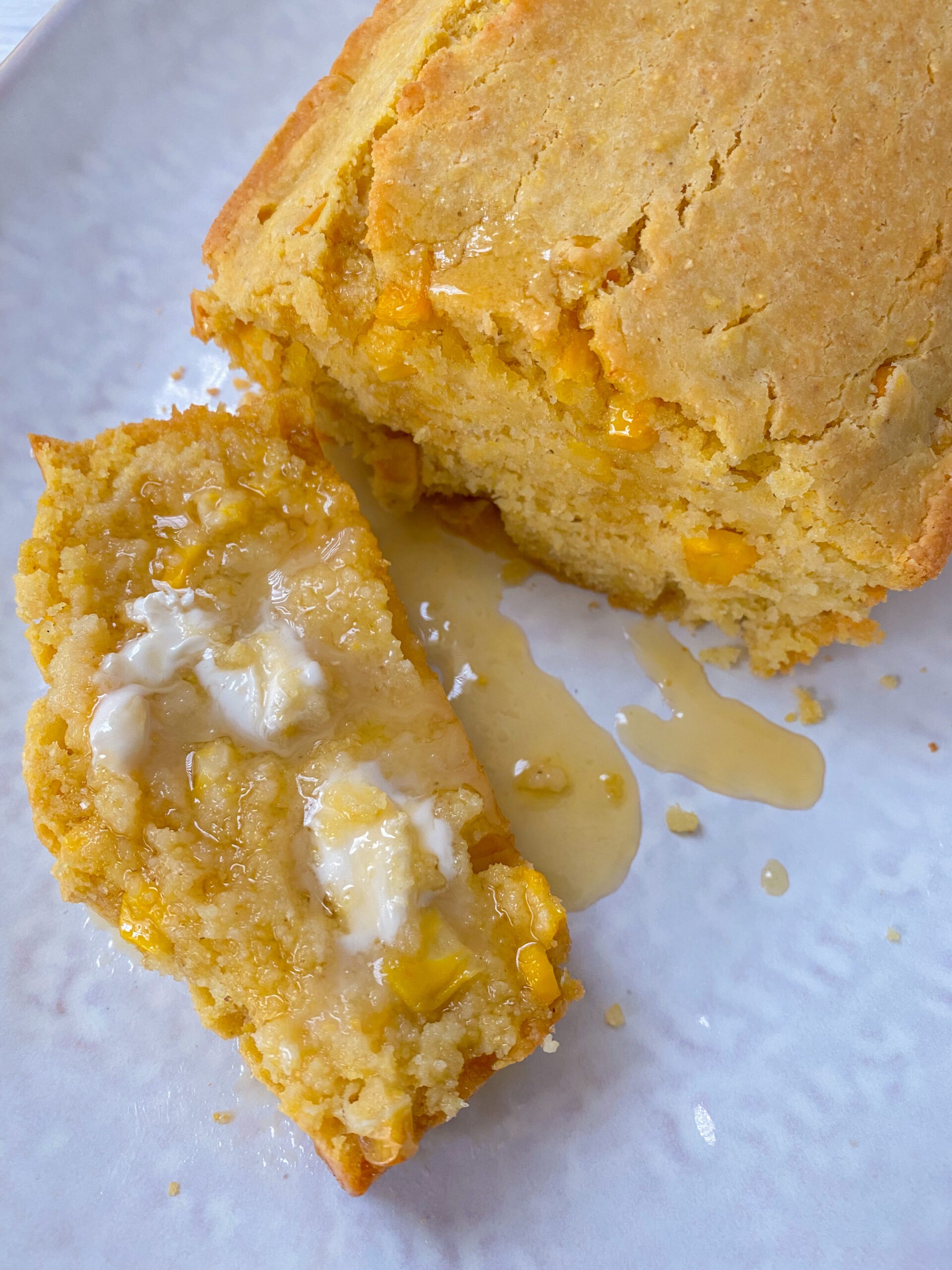 Vegan cornbread served with butter and maple syrup.