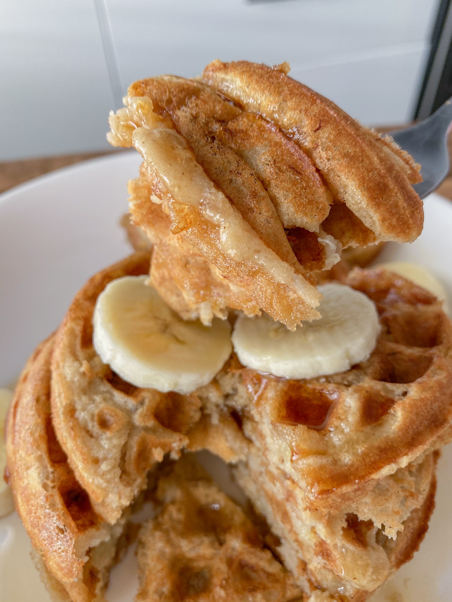 Bite of waffles on a fork.