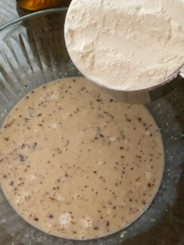 Adding flour to pancake mix.