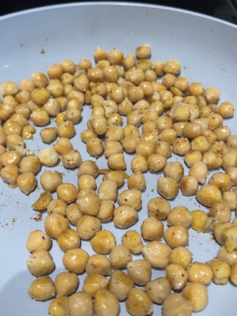 Crispy chickpeas cooking in a skillet.