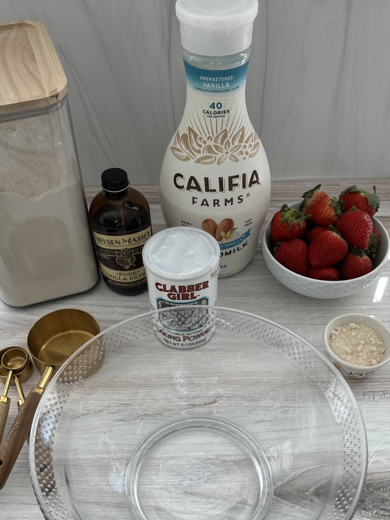Ingredients on a counter for making strawberry pancakes.