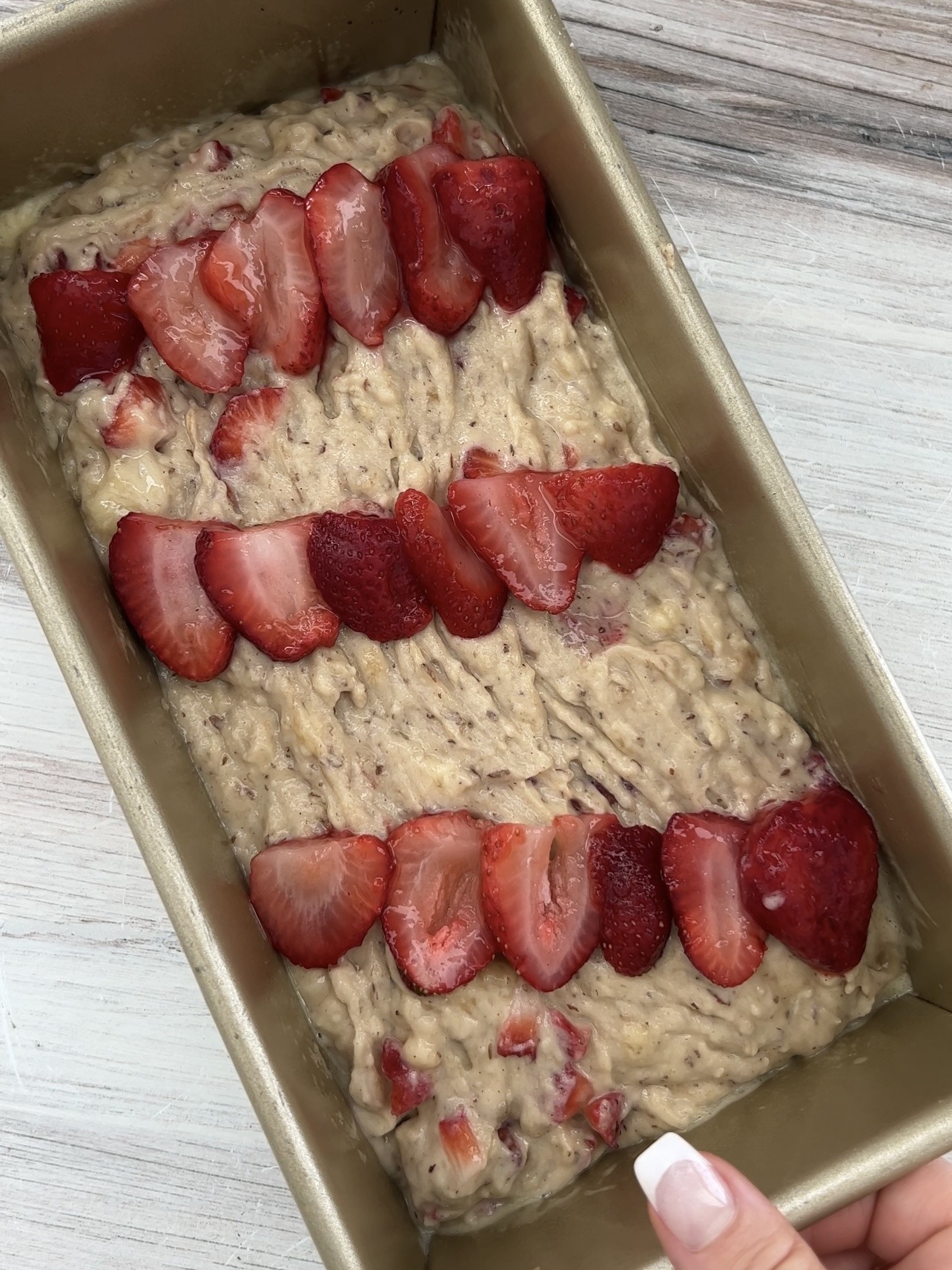 Vegan Strawberry Banana Bread

Step 4: Fold in the diced strawberries and then transfer the mixture into a greased metal loaf pan or a standard metal round pan. You may decorate the top of the strawberry banana bread with strawberries if you'd like.