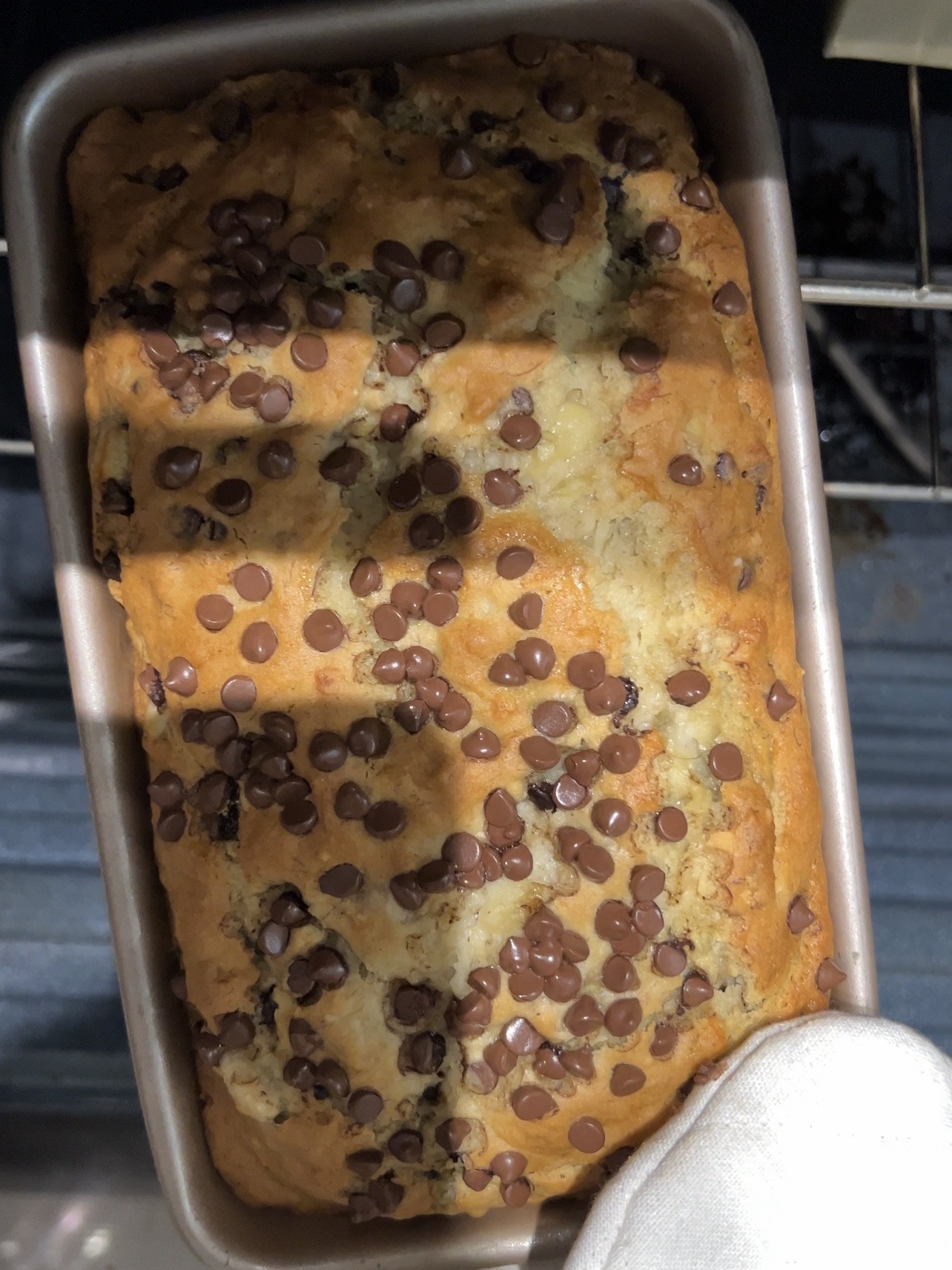Pulling chocolate chip banana bread out of the oven.