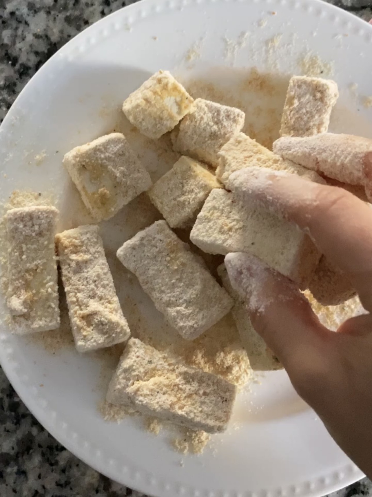 Step 2: In one bowl, mix the almond milk and cornstarch together. In another bowl, mix the flour, bread crumbs, and seasonings together. Dip the tofu pieces into the wet mixture and then immediately dip into the dry dredge. Set aside until ready to fry.