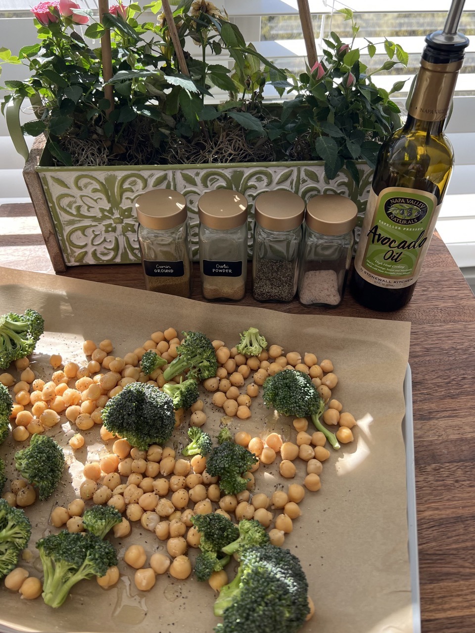 Preheat the oven to 400. Disperse the chickpeas and broccoli onto a baking sheet lined with parchment paper. Season them with salt and pepper, cumin, and garlic powder. Roast until crispy.