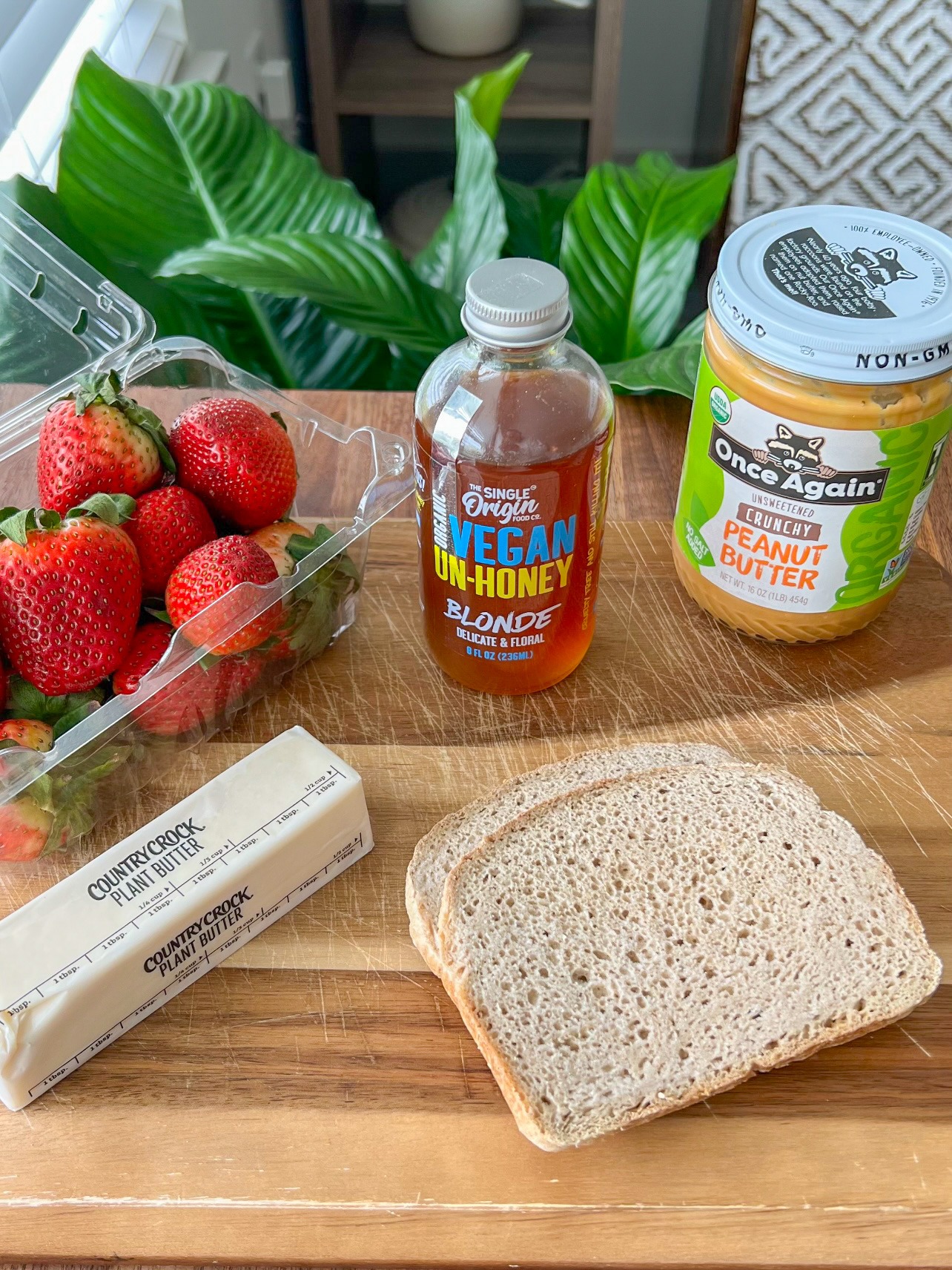 ingredients for the peanut butter and strawberry sandwich include vegan un-honey, peanut butter, strawberries, country crock plant-butter, and gluten-free bread