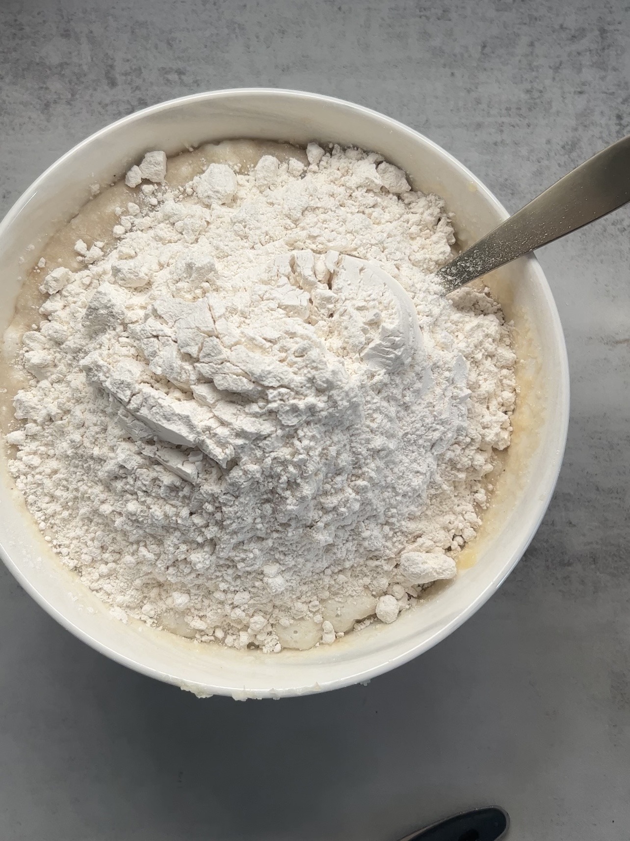 Adding the flour to the bowl.