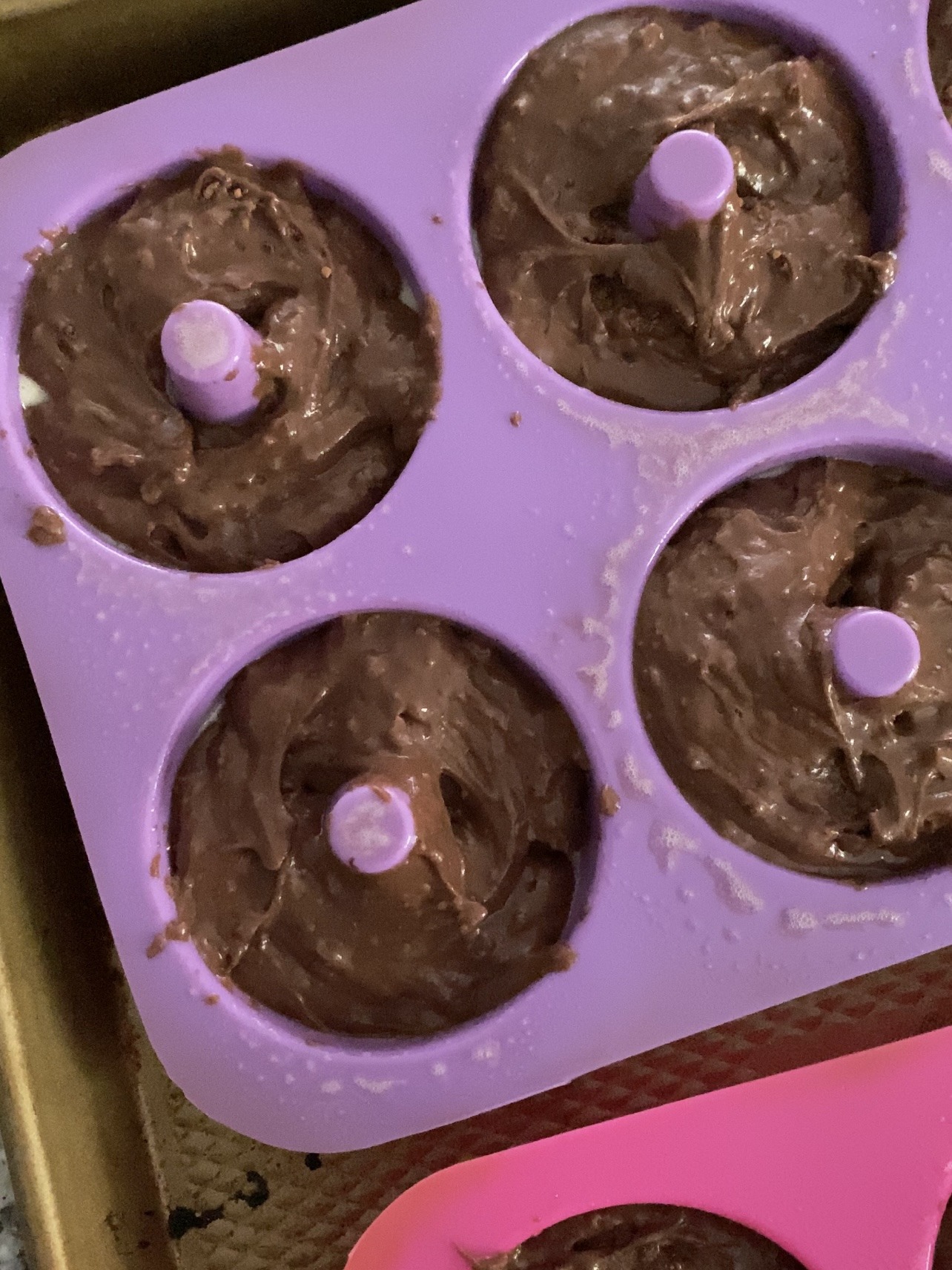 Chocolate donut batter in silicone molds.